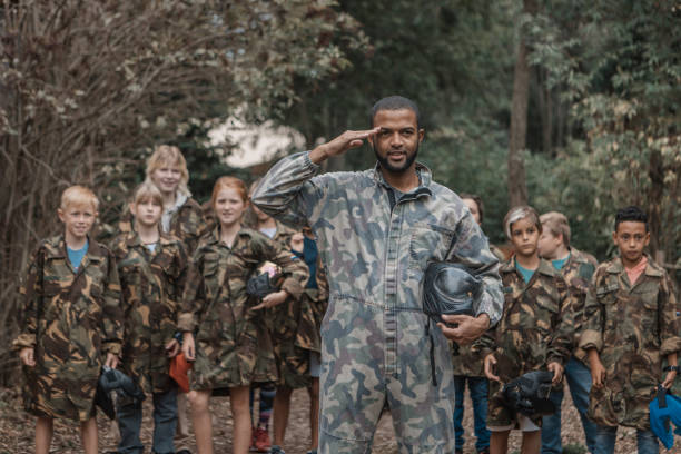 istock Black father coaching his children's paintball team 1420163635
