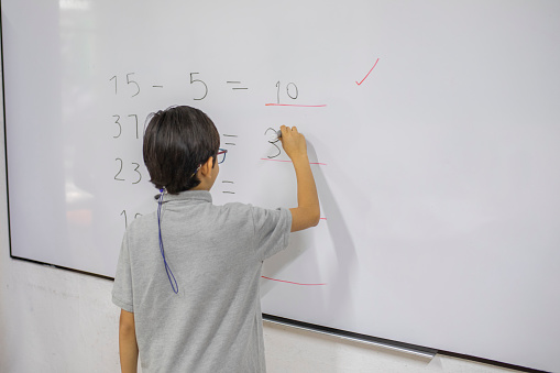 children writing on the blackboard