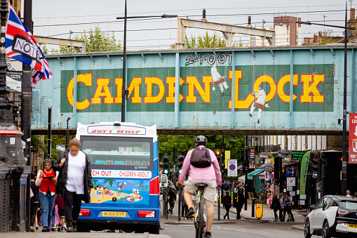 London, UK - 1 September, 2022: people walking on a busy street lined with shops and restaurants at Camden Lock in Camden Town, London, UK.