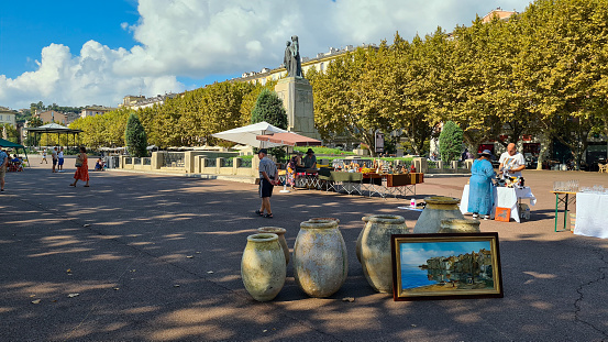 Bastia, France – August 31, 2022: A market day in front of Monument aux morts de Bastia in Saint Nicolas Square in Bastia.