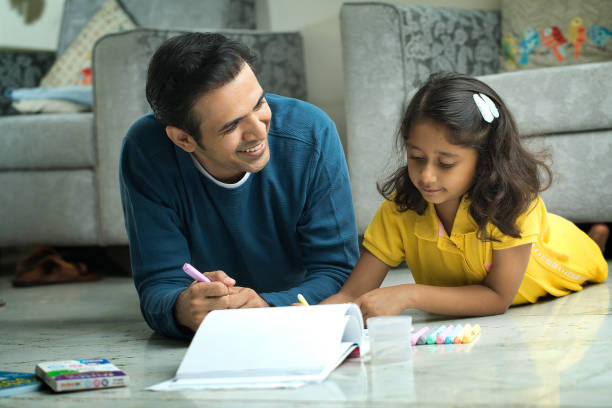 istock Father Lying On Floor And Teaching Her Daughter 1420169856