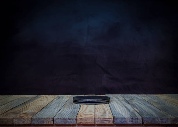 Wood table top with product mockup space on dark background.