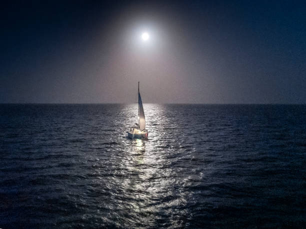 night sailing catamaran caribbean bahamas drone beautiful production catamaran is sailing through the clear waters of the bahamas catamaran sailing stock pictures, royalty-free photos & images