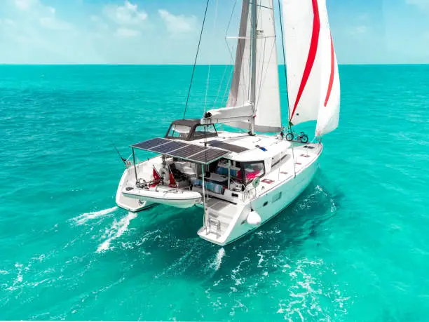 beautiful production catamaran is sailing through the clear waters of the bahamas