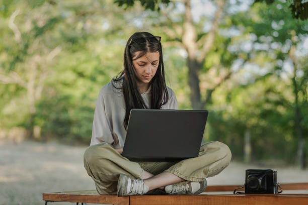 istock Freelancer working on a laptop outdoor 1420173224
