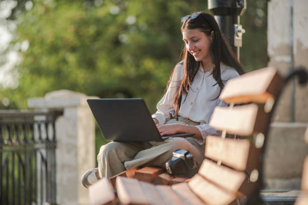 istock Freelancer working on a laptop outdoor 1420173952