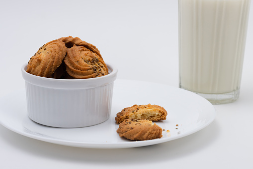 Cookies or biscuits and glass of milk for breakfast or snacks, a healthy concept lifestyle with copy space for text isolated on white background