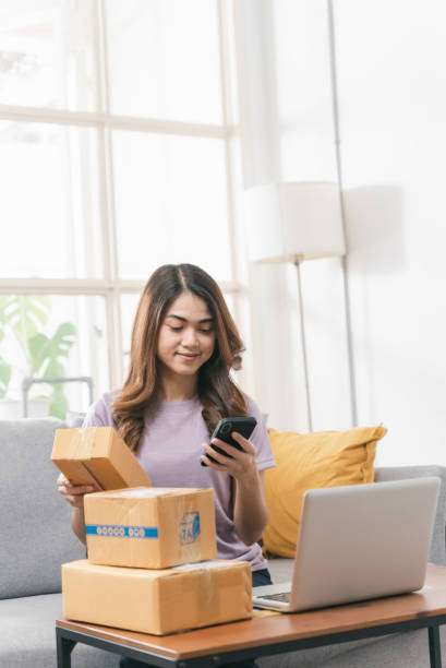 istock Young Asian woman checking electronic banking on smart phone as received order from customer. 1420177697