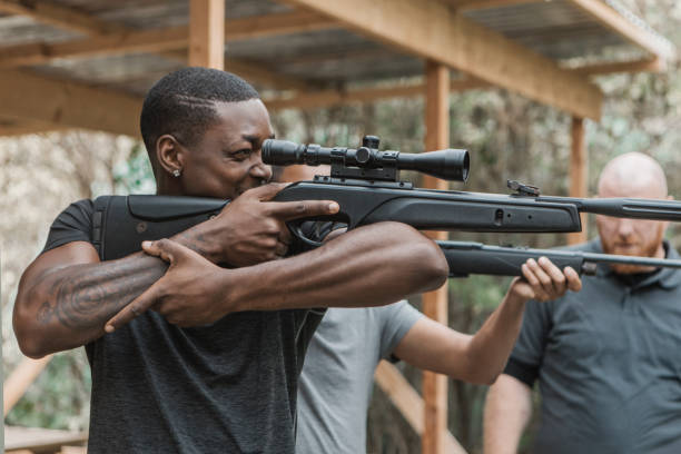 istock A redhead middle aged man trying rifle shooting with a younger black instructor 1420179379
