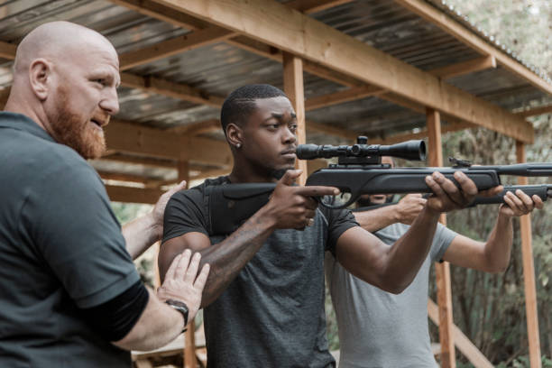 istock A redhead middle aged man trying rifle shooting with a younger black instructor 1420179381