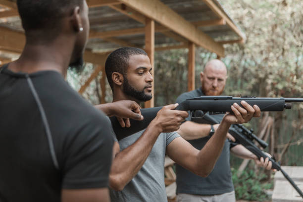 istock A redhead middle aged man trying rifle shooting with a younger black instructor 1420179391