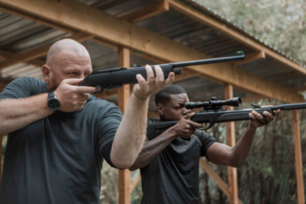 istock A redhead middle aged man trying rifle shooting with a younger black instructor 1420179400