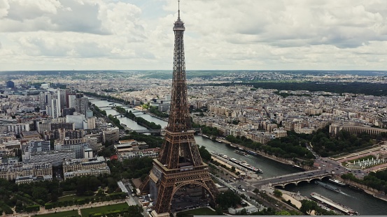 General view of the historic center of Paris with the Eiffel Tower and the river Seine on a cloudy summer day. Drone bird's eye view video, France, Paris