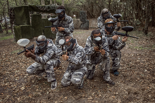 A paintball team during a game in a forest