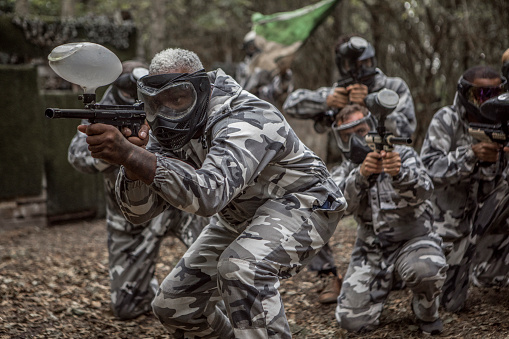 A paintball team during a game in a forest