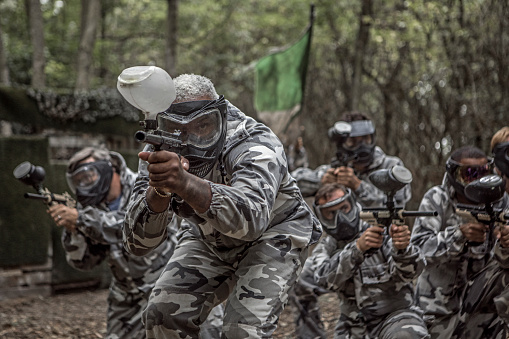 A paintball team during a game in a forest