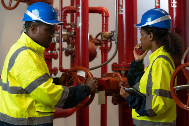 team of engineer or technician maintenance, checking, or test system springer prevent fire. group of african american contractor checking fire sprinkler system, pipe assembly, red fire pipe - commercial sprinkler system imagens e fotografias de stock