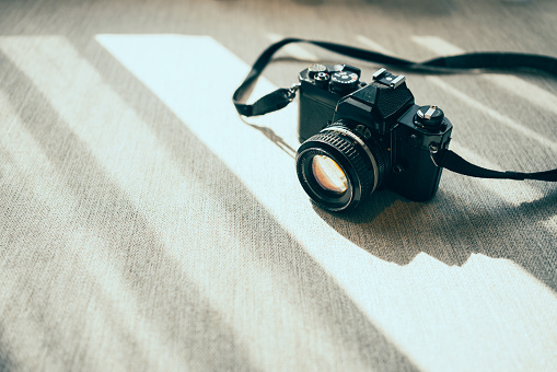 Vintage 1950s 35mm film camera isolated on white background, retro photography equipment