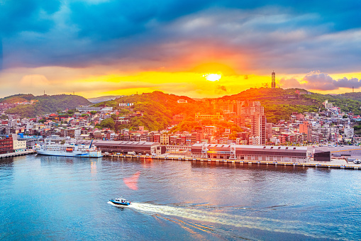 Taken in Keelung, Taiwan. A city based on a port.\nA boat on the sea with sunset.