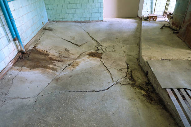 Destroyed concrete flooring due to subsidence of the base soil stock photo