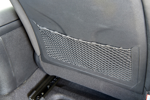 Close-up of the back of the car's front seatback, which has a pocket for storing small items.