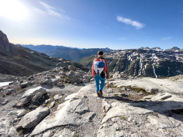 istock Male mountaineer walking on trail towards the crest 1420188921
