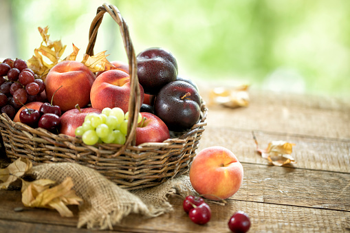 A beautiful still life with ripe juicy apples and branches with white flowers.