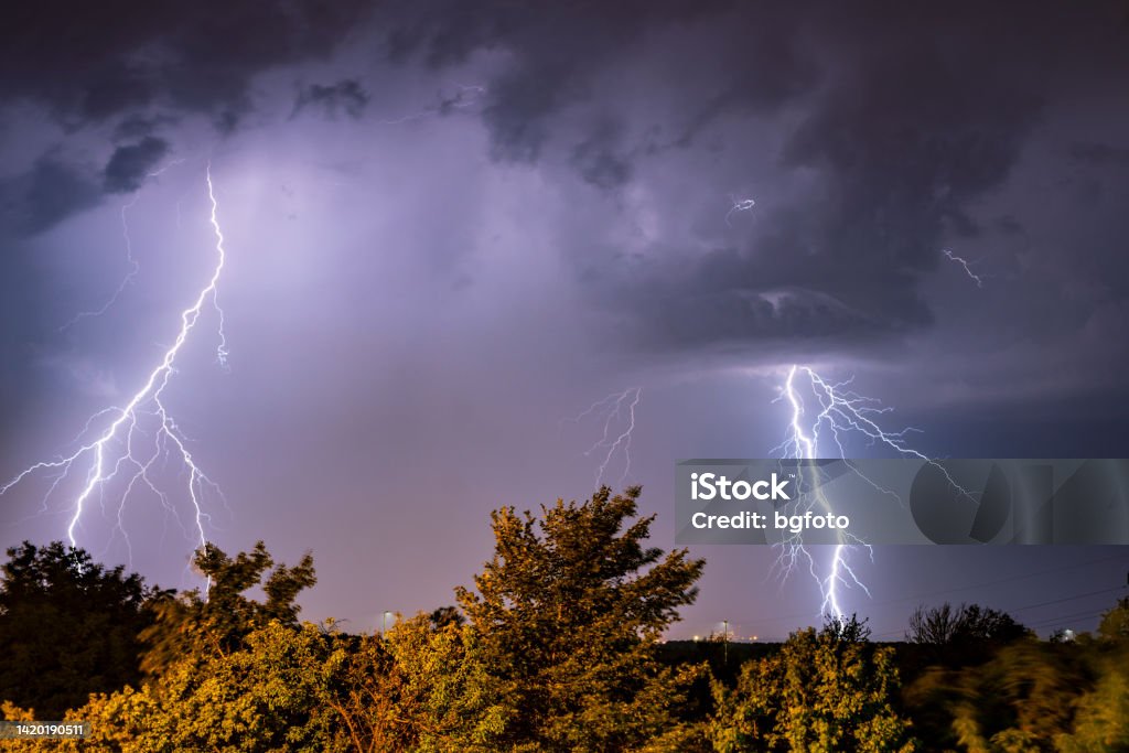 Real flashes of lightning during a thunderstorm A powerful storm forming late in the afternoon. Climate change photo. Lightning Stock Photo