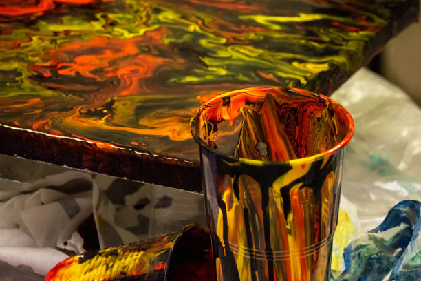 Mess on the artists desk. Liquid colorful dark resin art abstract background. Epoxy resin art painting space.