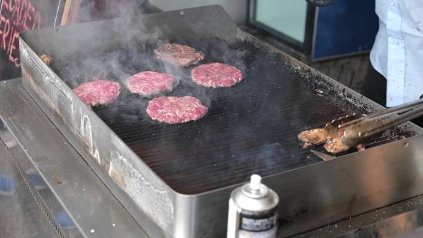 istock Fresh meat cutlets, patties in a grill. 1420192134
