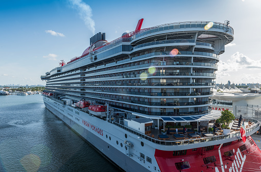Miami, USA - September 2, 2022: View of the beautiful cruise ship Scarlet Lady, of the Virgin Voyages company in the preparation process, at the cruise terminal, of the commercial port of Miami. Virgin Voyages is a cruise line headquartered in Plantation, Florida, with two fleet ships.