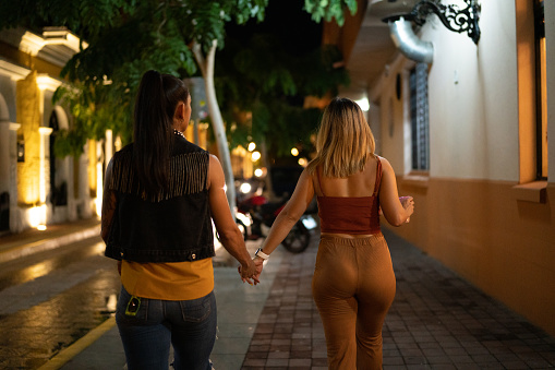 Lesbian couple walking at city