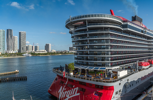 Miami, USA - September 2, 2022: View of the beautiful cruise ship Scarlet Lady, of the Virgin Voyages company in the preparation process, at the cruise terminal, of the commercial port of Miami. Virgin Voyages is a cruise line headquartered in Plantation, Florida, with two fleet ships.