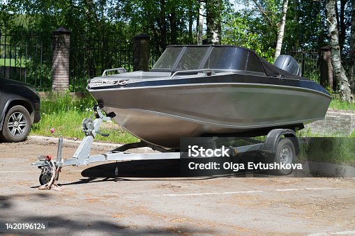 istock A boat or a boat with a motor on a trailer with wheels for transportation by car with a trailer 1420196124