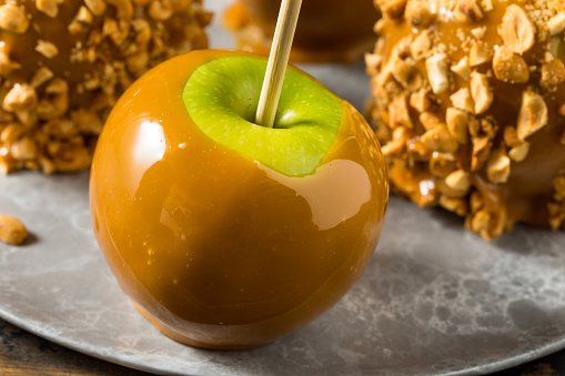 A tray of freshly made candy apples cool on a metal tray in a candy store window in Brevard, North Carolina.
