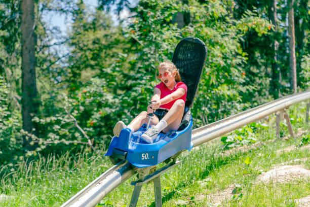 istock Teenage girl screams going down a mountain roller coaster 1420205678