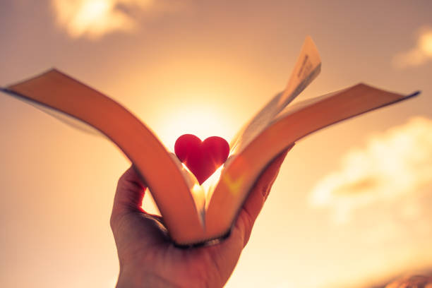 Open book and red heart in center.