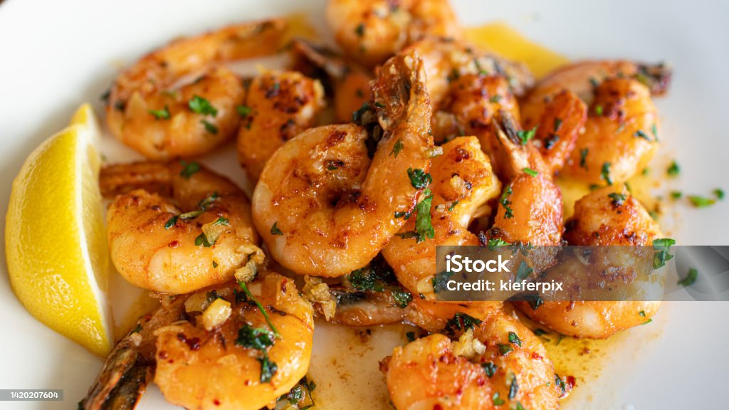Pan fried butter garlic shrimp on plate Pan fried butter garlic shrimps. Shrimp - Seafood Stock Photo
