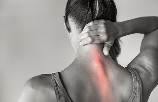 Mujer que sufre de dolor de espalda y cuello en la columna vertebral photo