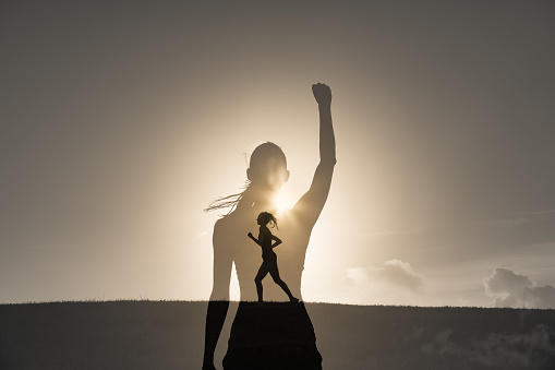 Double exposure of strong motivated woman running in the sunset. Never give up, inner strength and power concept.