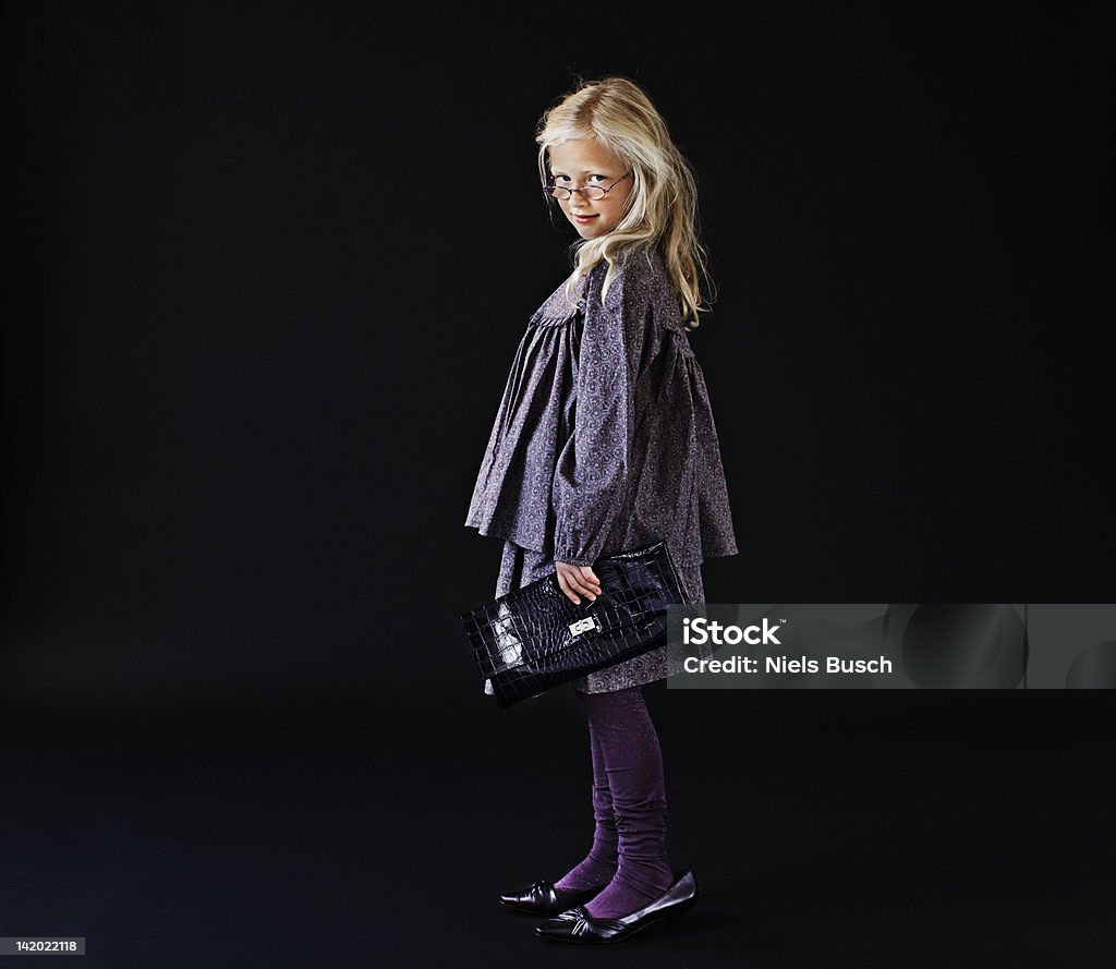 Girl dressing up in mothers shoes  6-7 Years Stock Photo