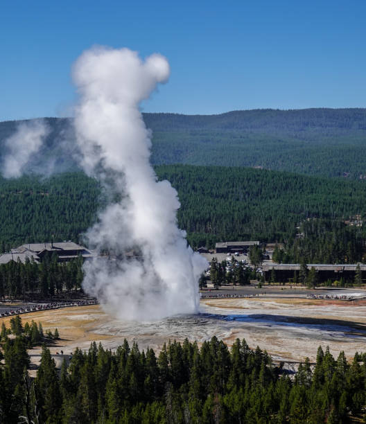 High above Old Faithful as it erupts for a large crowd, Yellowstone.