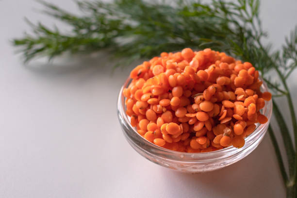 Red lentils. Benefits of legumes. National cuisine. Source of omega fatty acids. Orange garnish.