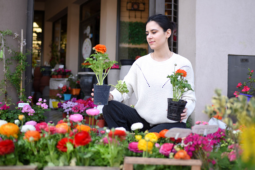 woman choosing plants and flowers for her garden
