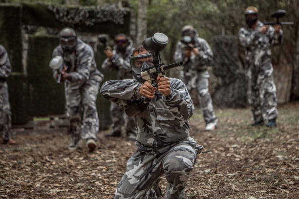 istock A mixed race middle aged male paintball team in action 1420224650