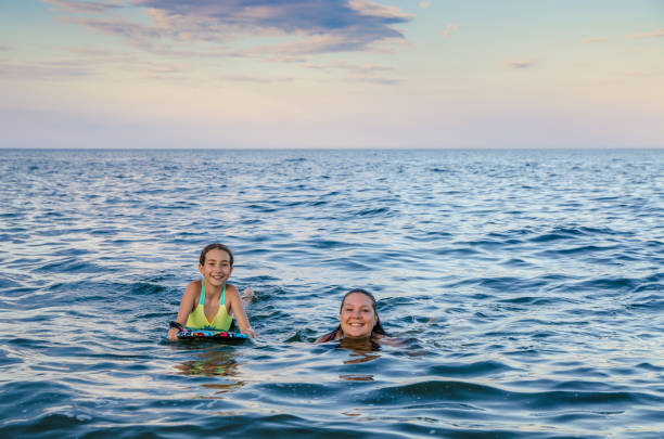 istock Mother and daughter in the Atlantic Ocean 1420226617