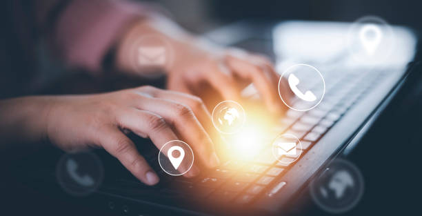 istock Communication and Contact us or Customer support hotline people connect. Hand using a laptop and touching on virtual screen contact icons, email and address, live chat with internet wifi. 1420226912