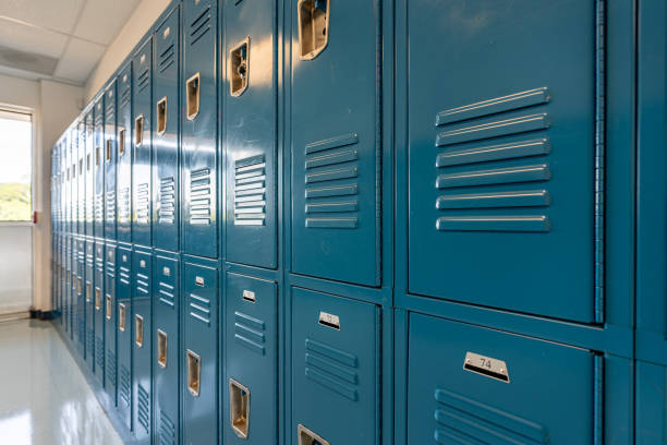 istock Blue metal lockers along a nondescript hallway in a typical US High School.  No identifiable information included and nobody in the hall. 1420229002