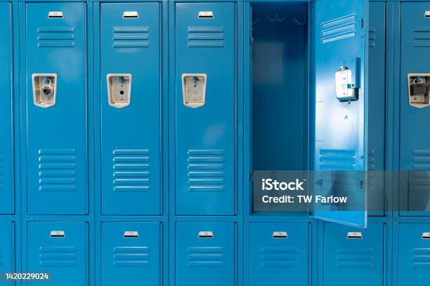 Single Open Empty Blue Metal Locker Along A Nondescript Hallway In A Typical Us High School No Identifiable Information Included And Nobody In The Hall Stock Photo - Download Image Now