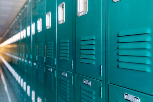 istock Green metal lockers along a nondescript hallway in a typical US High School.  No identifiable information included and nobody in the hall. 1420229115